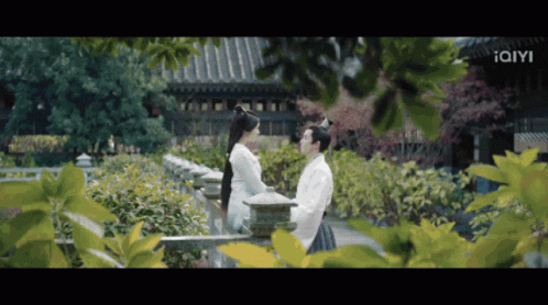 Man and Woman Standing Near Building With Iam