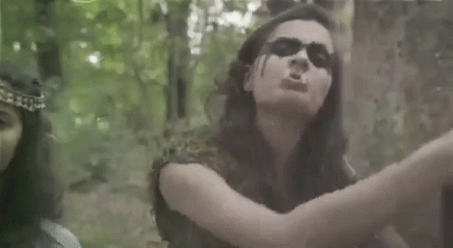 Man and Woman Standing Next to Each Other in Forest