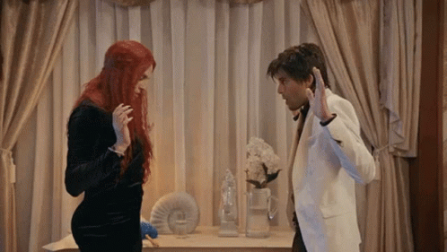 Man And Woman Standing Next To Each Other GIF