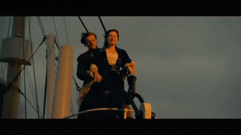 Man And Woman Standing On A Boat GIF