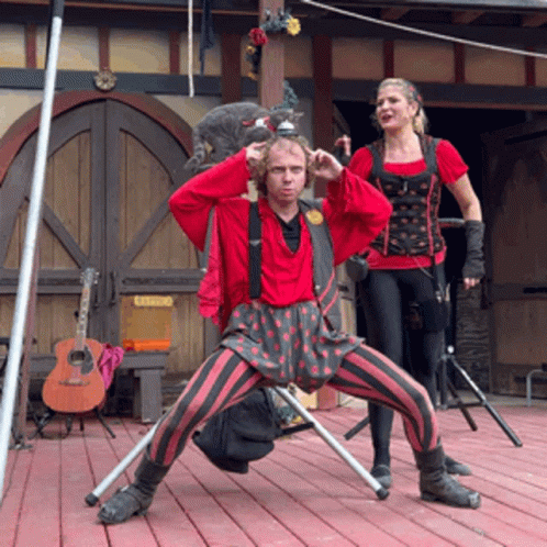 Man And Woman Standing On Stage With Catering Sign GIF