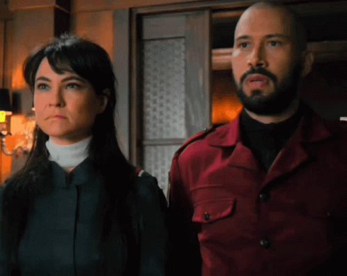 Man And Woman Standing Together Looking At Something GIF