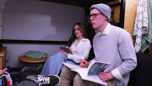 Man And Woman Studying Statistics Textbook GIF