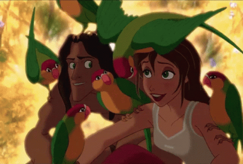 Man and Woman Surrounded by Colorful Parrots