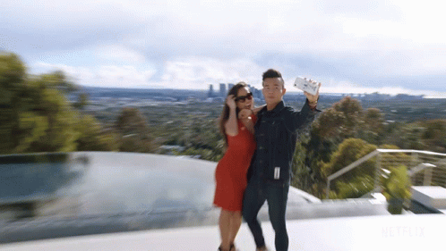 Man And Woman Taking Selfie With Netflix Logo GIF