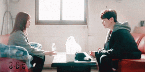 Man And Woman Talking At Table GIF