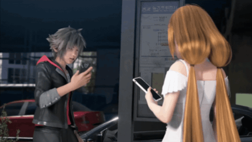 Man and Woman Talking in Front of Sign Saying A
