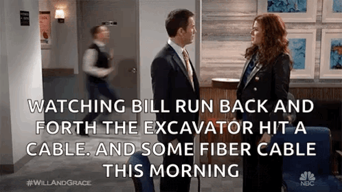 Man And Woman Talking In Hallway GIF