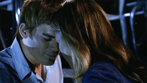 Man and Woman Touching Foreheads in Dark Room