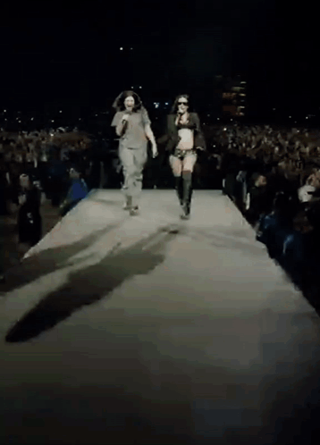 Man And Woman Walking Down Runway GIF