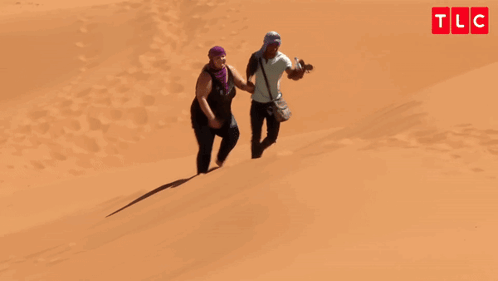 Man and Woman Walking Down Sand Dune Oh My God You're Lazy