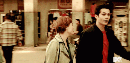 Man and Woman Walking Down Street With MTV Logo
