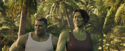 Man and Woman Walking in Lush Green Forest