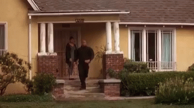 Man and Woman Walking Into House