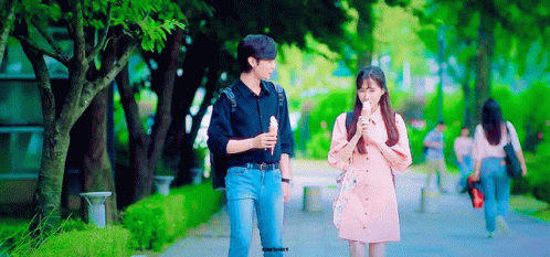 Man And Woman Walking On Sidewalk GIF