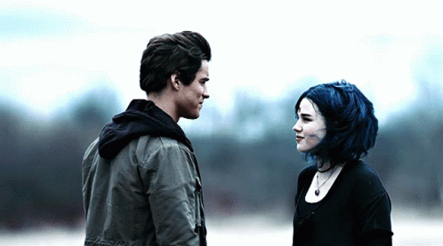 Man And Woman With Blue Hair Looking At Each Other GIF