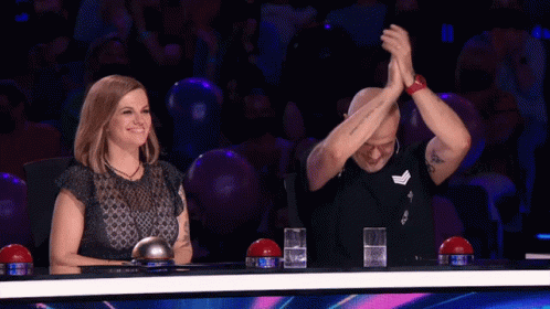 Man and Woman With Hands in Air