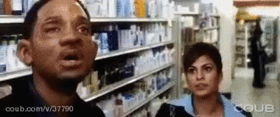 Man And Woman With Mouths Open In Store GIF