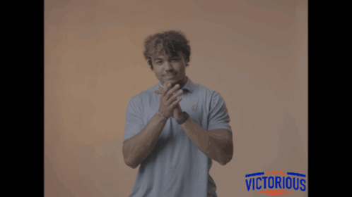 Man Applauding in Front of Victorious Sign