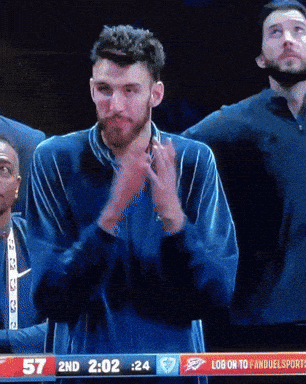 Man Applauds During Basketball Game
