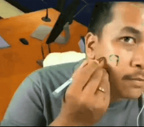 Man Applying Makeup While Wearing Ring GIF