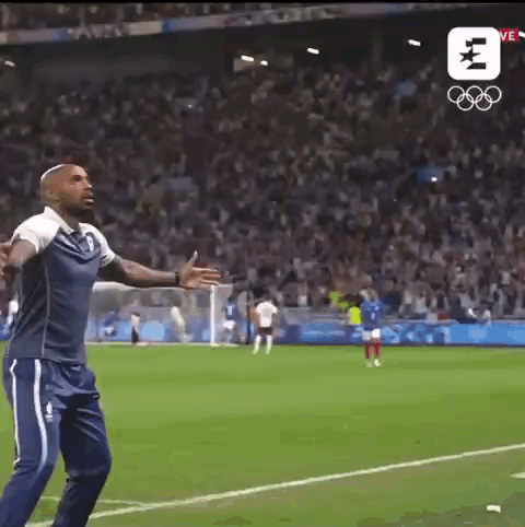 Man Arms Outstretched in Front of Crowd on Soccer Field