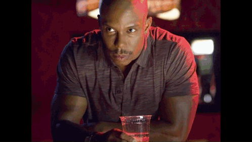 Man At Bar Holding Plastic Cup Of Water