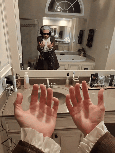Man at Bathroom Sink With Hands Up
