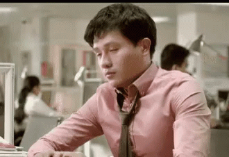 Man At Desk In Pink Shirt And Tie GIF