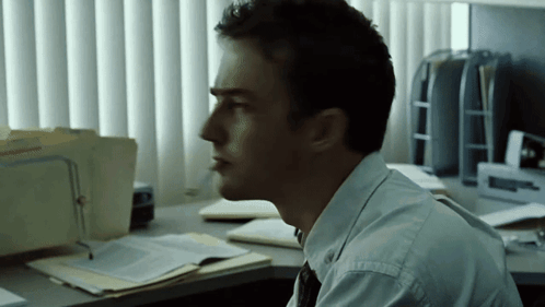 Man at Desk with Attorney Folder by Window
