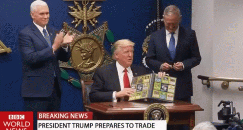Man at Desk With BBC World News Headline