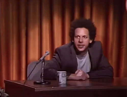 Man At Desk With Hands In Air GIF
