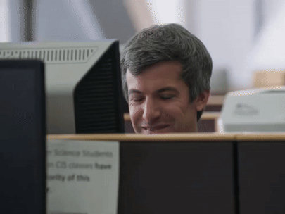 Man at Desk With Science Students Sign