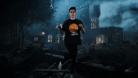 Man At Haunted House With Pumpkin Shirt GIF