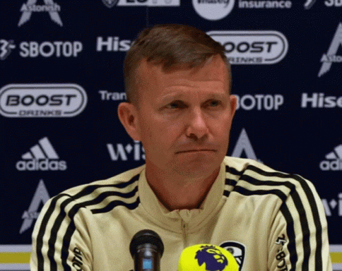 Man At Microphone In Front Of Sbotop Banner GIF