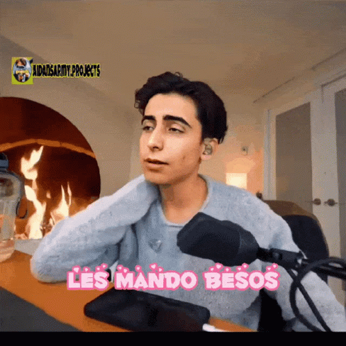 Man at Microphone Saying Les Mando Besos