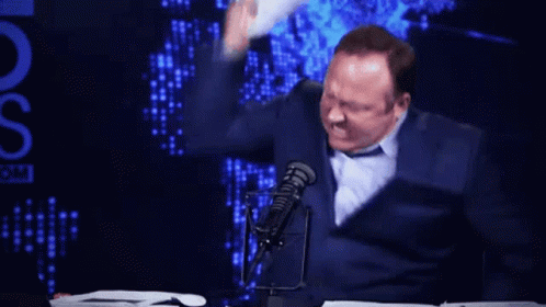 Man At Microphone With Stack Of Papers And OS GIF