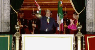 Man at Podium Holding Flag