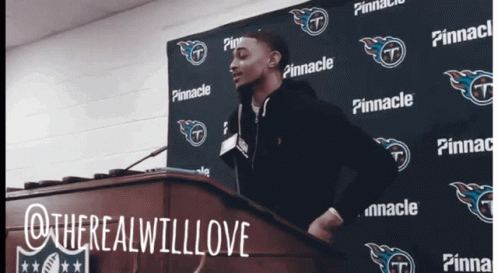 Man at Podium in Front of Pinnacle Sign