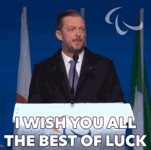Man At Podium Wishes Best Of Luck GIF