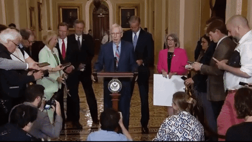 Man at Podium with Congress Sign