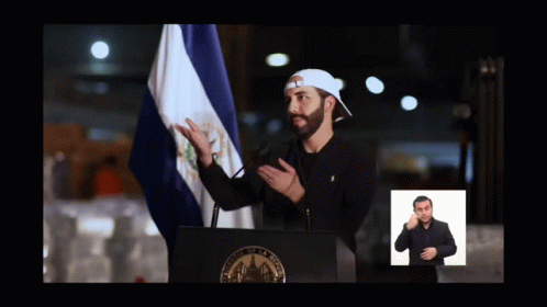 Man at Podium With Flag and Sign Language Sign