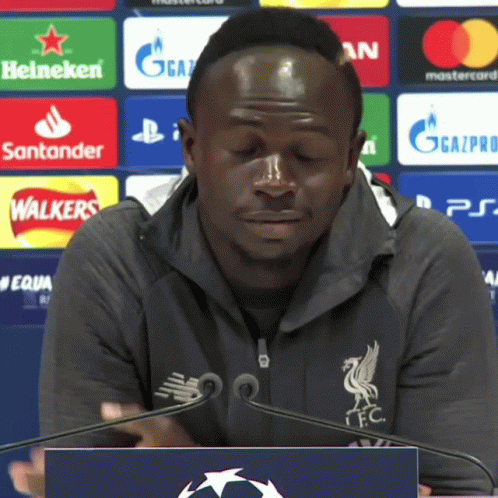 Man At Podium With Heineken Santander Mastercard Logos GIF