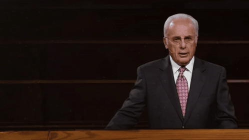 Man at Podium With John MacArthur Quote