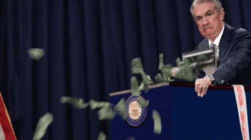 Man at Podium With Money Flying Out