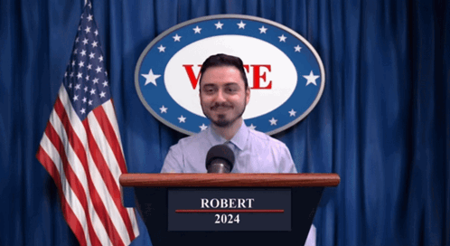Man At Podium With Robert 2024 GIF