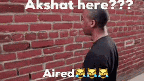 Man at Red Brick Wall Says Akshit Here
