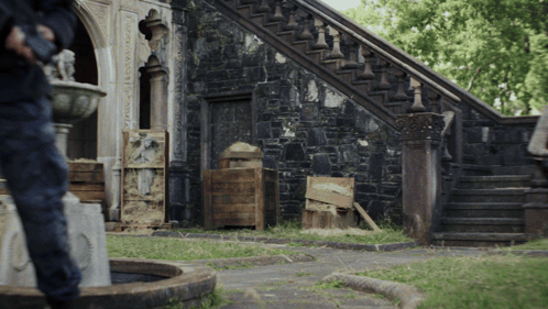 Man at Stone Building with Stairs and Fountain