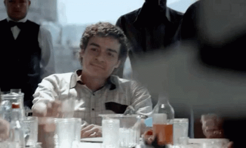 Man at Table With Bunch of Glasses