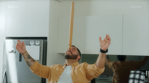 Man Balance Rolling Pin On His Nose GIF